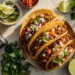 Ground beef tacos with cheese, lettuce, salsa, and guacamole — a quick and easy 30-minute family meal.