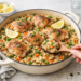 One-pan roasted pork tenderloin with root vegetables, golden and caramelized, served in a skillet with fall flavors.