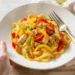 One-pan chicken fajita pasta with bell peppers and onions, creamy and colorful in a skillet.