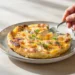 One-pan frittata with eggs, vegetables, and cheese, lightly golden and ready to serve.