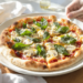 Quick vegetarian pizza using store-bought dough, topped with vegetables and melted cheese.