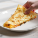 Budget-friendly cheese and vegetable quesadillas cut into slices, quick meal for feeding a crowd.