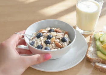 Diabetic-friendly breakfast with eggs, whole grain, berries, and nuts on plate for blood sugar control