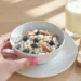 Diabetic-friendly breakfast with eggs, whole grain, berries, and nuts on plate for blood sugar control