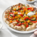 Vegetarian naan pizza with roasted vegetables and cheese, quick and easy flatbread meal.