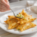 Potato and pea samosas, quick vegetarian pastries with a golden, crispy shell.