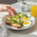 Quick healthy breakfast for energy boost with fruits, eggs, and whole grains on a bright kitchen table