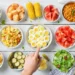 A spread of 15 colorful cookout side dishes including pasta salad, coleslaw, and grilled vegetables on a picnic table