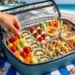 Easy beach food ideas with sandwiches, fresh fruit, and snacks, perfect for a summer picnic by the sea