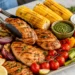 Beginner summer grilling recipes with burgers, corn, and veggies on a backyard grill