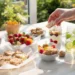 Healthy summer snacks with fresh fruit, yogurt, nuts, and light bites on a bright table