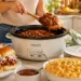 Summer crockpot family meal with fresh vegetables and herbs in a slow cooker
