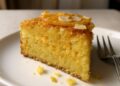 Sliced orange almond polenta cake with a tender golden crumb and fresh citrus zest on top