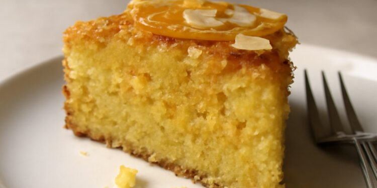 Sliced orange almond polenta cake with a tender golden crumb and fresh citrus zest on top