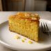 Sliced orange almond polenta cake with a tender golden crumb and fresh citrus zest on top
